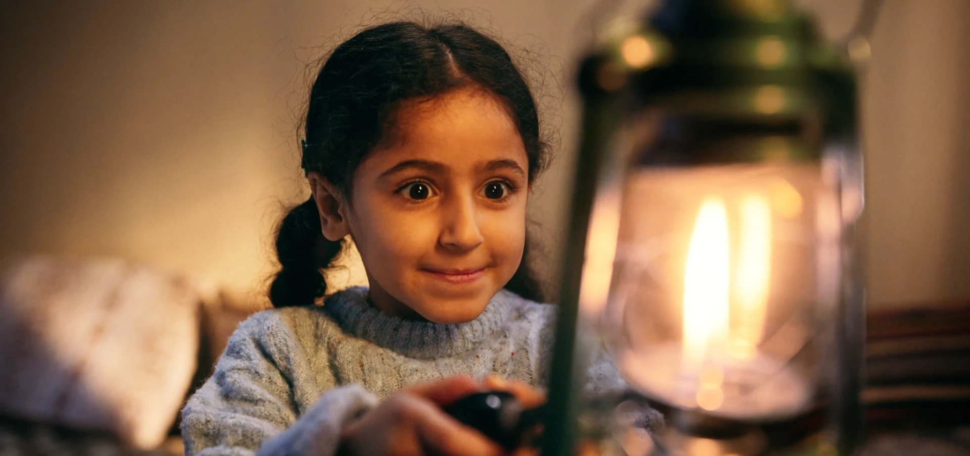 A young girl looking towards a lit lantern in UNRWA's Al Thabat Ramadan campaign film